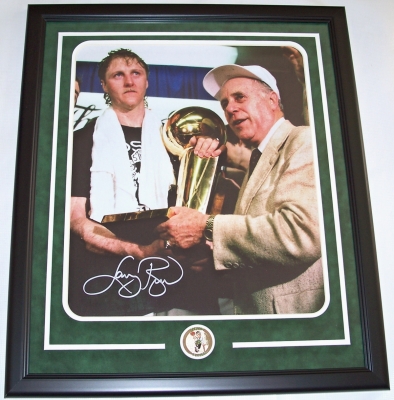 Larry Bird Autographed Boston Celtics 16x20 Color Photo with Red Auerbach and Trophy ~ Custom Framed with a team medallion
Larry Bird has personally autographed this 16x20 Color photo with a Silver Paint Pen, and it comes custom framed and double matted. The black frame measures 22x26 inches. The double matting consists of a Hunter green suade top matting over a white bottom mat. There is also a team medallion centered below the autographed collectible. This custom made frame is ready to hang on the wall! Red Auerbach has not signed the photo. What a great shot of them celebrating together after winning the Championship! The signed photo has a NEW REAL DEAL Memorabilia Authenticity Hologram on it and the Real Deal Memorabilia Certificate of Authenticity (COA).
Keywords: LB16x20RedF