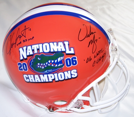 Chris Leak AND Urban Meyer Dual Autographed Florida Gators National Championship Logo Full Size Authentic Helmet with "2006 BCS MVP" AND "06 NAT CHAMPS" inscriptions
2006 National Championship Quarterback Chris Leak AND Coach Urban Meyer have both personally hand signed special Full Size Championship Gators Authentic Helmet.  This Riddell Authentic Full Size Helmet has the Championship logo on one side and a Gators logo on the other, so you get the best of both worlds!  Chris added his "2006 BCS MVP" inscription below his signature, which was signed on March 9, 2007.  Coach Meyer added his "06 NAT CHAMPS" inscription below his signature, which was signed on March 14, 2007, in Gainesville, FL.  This item comes with The REAL DEAL Memorabilia deluxe Authenticity, you will receive 1. Two large photos of Chris and Urban signing your type of item, 2. a detailed Certificate of Authenticity, and 3.  Matching REAL DEAL Authenticity Holograms on all items!
Keywords: CLUMAHChamps