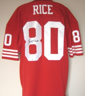 Jerry Rice Autographed Red Custom Throwback Jersey with RICE Hologram
Jerry Rice has won 3 Super Bowls with San Francisco (1989,90,95) and has been named a 10-time All-Pro. He was the regular season MVP in 1987 and Super Bowl MVP in 1989. Rice also holds the NFL all-time regular season and Super Bowl leader in touchdowns, receptions and receiving yards.  This is a Custom Throwback Jersey that was hand signed by Jerry Rice.  This custom jersey has sewn on letters and numbers and is made with top quality materials. This item has Jerry Rice's personal  Authenticity Hologram on the jersey, along with a numbered Authenticity Hologram and Certificate of Authenticity from Tri Star Productions, and can varified on their website once purchased.  Brought to you by The REAL DEAL Memorabilia, get THE REAL DEAL!

Keywords: JRJTri