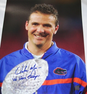 Urban Meyer Autographed Florida Gators National Championship 16x20 "Trophy" Photo with "06 NAT CHAMPS" inscription
2006 National Championship Coach Urban Meyer has personally hand signed this National Championship "Trophy" 16x20 photo with a Blue sharpie pen.  Coach Meyer added his "06 NAT CHAMPS" inscription below his signature, which was signed on March 14, 2007, in Gainesville, FL.  This item comes with The REAL DEAL Memorabilia deluxe Authenticity, you will receive 1. A large photo of Urban signing, 2. a detailed Certificate of Authenticity, and 3.  Matching REAL DEAL Authenticity Holograms on all items! 
Keywords: UM16x20Trophy